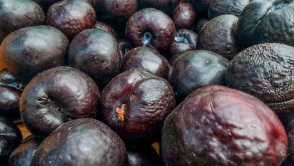 Many ripe plums sold sold in the market.