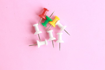 plastic thumbtacks in colorful background