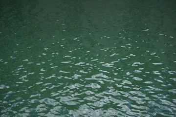 Emerald green colored water surface of river