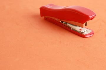 red stapler in color background