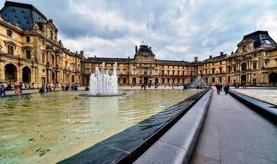 Louvre in Paris in the clouds