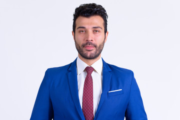 Portrait of handsome bearded Persian businessman wearing suit
