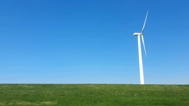 Thanksgiving against the blue sky. Windmill park in the lake IJsselmeer in Flevoland Netherlands. View from the car window at speed.