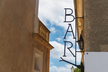 Fototapeta na wymiar Metal sign with BAR lettering on a house wall
