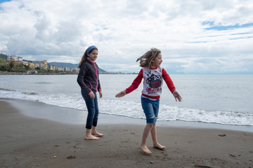 Mädchen spielen am Strand von Salerno Italien