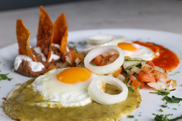 Huevos divorciados, fried eggs on corn tortillas with salsa verde and roja, mexican breakfast