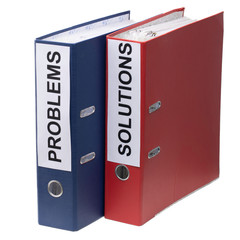 Problems and Solutions - two binders with text on desk in the office