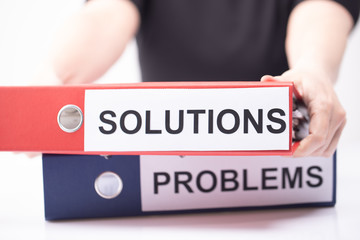 Problems and Solutions - two binders with text on desk in the office