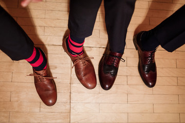 Men's feet in stylish shoes and funny socks. male style.