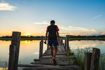 Man walking on wooden bridge