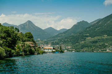 Panoramic view on Iseo lake with hills how background