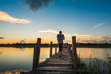 Man walking on wooden bridge