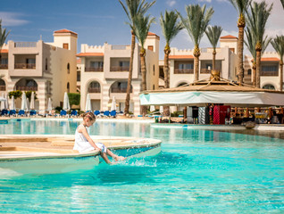 Kid doing activities by the pool