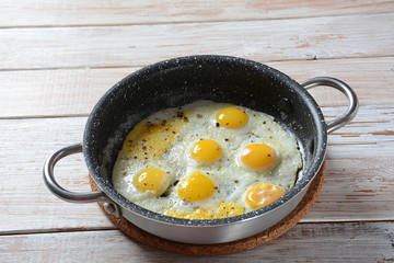 Fried quail eggs in a pan for breakfast. Healthy organic food