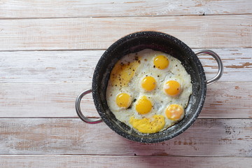 Fried quail eggs in a pan for breakfast. Healthy organic food
