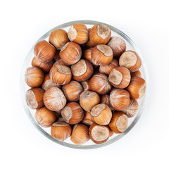 Filbert nuts in glass bowl isolated on white background with clipping path