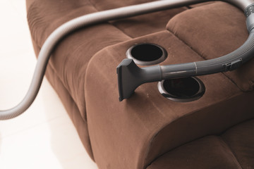 Close up of vacuum cleaner in the sofa