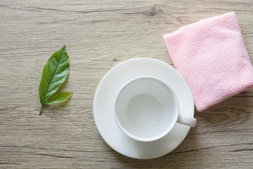 Close up woman hand cleaning coffee cup on the morning with microfiber cloth,Close up woman hand cleaning coffee cup on the rustic wood table.