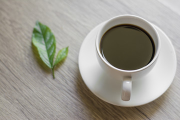 Coffee espresso on wood table nature background in garden,warm tone