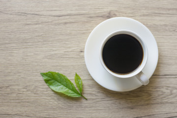 Coffee espresso on wood table nature background in garden,warm tone