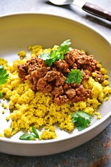Cauliflower rice with turmeric and beef beef bolognese sauce. Paleo and keto diet dish