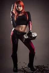 sensual woman with gun standing on cartridge case