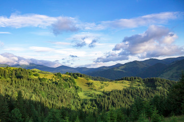 Scenic summer or spring mountain view with cloudy sky. Ukraine, Carpathians, Dzembronia High mountains in vivid color. Nobody. Beautiful mountain lanscape or valley.