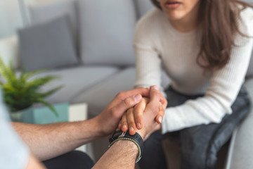 Male hands holding female, caring loving understanding man showing comfort and empathy, giving psychological support to woman in marriage relationships concept, couple reconciliation, close up view