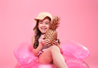 Obraz na płótnie Canvas cheerful summer girl with pineapple on colored background