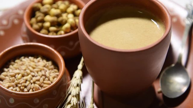 Sattu sharbat is a cooling sweet drink made in summer with roasted black chickpea flour, barley, suger, salt & water. served in a glass. selective focus