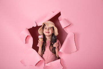 funny little girl with ice cream on colored background