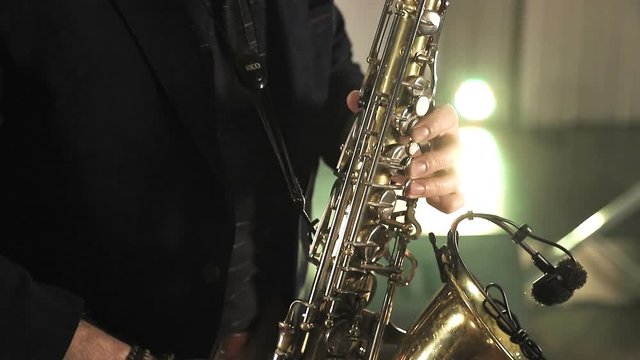 Saxophonist play on golden saxophone. Jazz music.