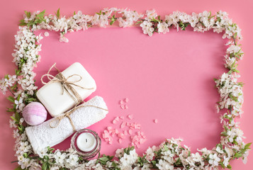 Spa still life on an isolated pink background with spring flowe