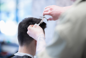 Men's haircut in barbershop. Shave a dangerous razor.