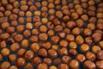 Lots of Gulab Jamun (An Indian sweet dish) dipped in flavored sugar syrup
