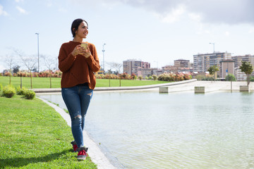 Pensive young mixed race woman walking over riverside