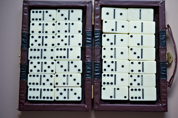 The whole set of dominoes in an old-fashioned chest, ordered.