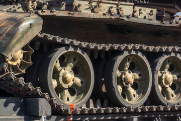 Fototapeta na wymiar Crest tracks of caterpillars on battle tank wheels
