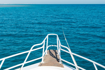 Fototapeta premium View from the yacht to the open sea. Ship in open sea is showing the bow in a summer day