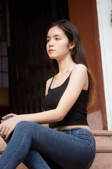 Portrait of thai china adult beautiful girl black shirt blue jeans relax and smile