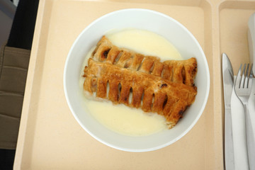 Delicious apple strudel with custard and fruit salad in a canteen in Germany