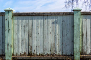 Old wooden fence with peeling faded paint and place for text