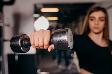 Fitness workout with dumbbell in hand. Close up.