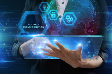 The concept of business, technology, the Internet and the network. A young entrepreneur working on a virtual screen of the future and sees the inscription: Business transformation