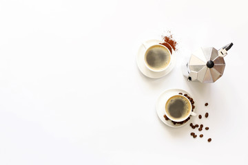 Obraz na płótnie Canvas Two cups of espresso . Coffee beans, ground coffee on white background