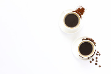 Two cups of espresso . Coffee beans, ground coffee on white background