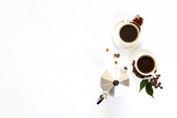 Two cups of espresso . Coffee beans, ground coffee on white background