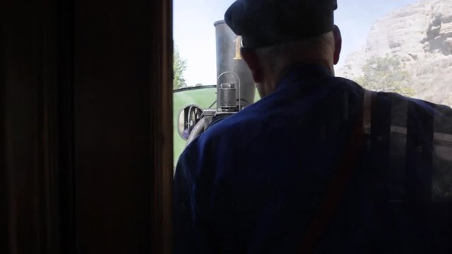 view from the vagon of the steam engine and the conductor in an old steam train