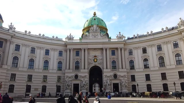 Vienna, Austria. March 18, 2019 - 4k video Wide view of north facade with Michaelertrakt green dome of Alte Hofburg or Hapsburg Palace in Michaelerplatz, Wien