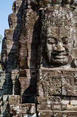 Fototapeta premium Smiling Faces of Bayon Temple in Angkor Thom is The Heritage of Khmer Empire at Siem Reap Province, Cambodia.